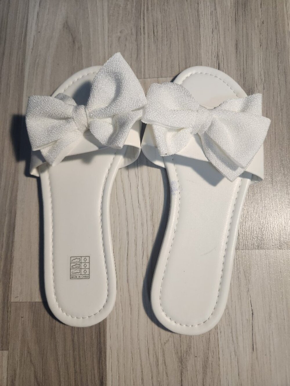 White sandals with a bow